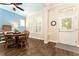 Charming dining room with wood floors, a round table, and windows with white shutters by the front door at 6015 Shell Ridge Dr, Lithia, FL 33547