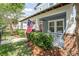 Inviting front porch with classic white railing, an American flag, and lush landscaping at 6015 Shell Ridge Dr, Lithia, FL 33547