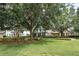 Attractive home with a well-kept lawn, mature trees, and tidy landscaping enhancing its curb appeal at 6015 Shell Ridge Dr, Lithia, FL 33547