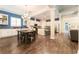 Open-concept kitchen and dining room with blue accent wall, granite countertops, island and modern stainless appliances at 6015 Shell Ridge Dr, Lithia, FL 33547