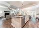 Open-concept kitchen featuring a center island with stainless steel appliances and pendant lighting with breakfast area at 6015 Shell Ridge Dr, Lithia, FL 33547