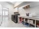 Functional laundry room with modern washer and dryer, and ample shelving space at 6015 Shell Ridge Dr, Lithia, FL 33547