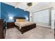 Comfortable main bedroom featuring a large bed, an accent wall, and shuttered windows at 6015 Shell Ridge Dr, Lithia, FL 33547