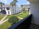 Balcony view of the community shows well-manicured grounds, a swimming pool, and mature palm trees at 631 Haven Pl, Tarpon Springs, FL 34689