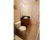 Bathroom with tile flooring, toilet, vanity with sink, mirror and light fixture at 631 Haven Pl, Tarpon Springs, FL 34689