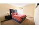 Bedroom with neutral carpeting features a queen bed with padded headboard and side tables with lamps at 631 Haven Pl, Tarpon Springs, FL 34689