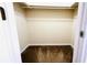 An empty walk-in closet with beige walls, brown carpet, and a door at 631 Haven Pl, Tarpon Springs, FL 34689