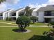 Serene view of the complex exterior and common green spaces at 631 Haven Pl, Tarpon Springs, FL 34689