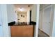 Kitchen pass-through with black granite countertop to dining room at 631 Haven Pl, Tarpon Springs, FL 34689
