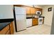 Kitchen with appliances, tile floor and warm wood cabinets at 631 Haven Pl, Tarpon Springs, FL 34689