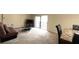 Open living area features neutral carpeting, a sofa, and sliding glass doors to the outdoor balcony at 631 Haven Pl, Tarpon Springs, FL 34689