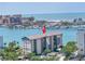 Aerial view of beautiful waterfront condo with stunning views, a marina, and mature landscaping at 650 Island Way # 204, Clearwater Beach, FL 33767