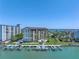 Waterfront condominium building featuring private boat slips and well maintained grounds at 650 Island Way # 204, Clearwater Beach, FL 33767