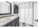 Updated bathroom featuring granite countertops, modern lighting, and a shower-tub combination at 650 Island Way # 204, Clearwater Beach, FL 33767