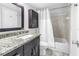 Updated bathroom vanity featuring granite countertops, modern lighting, and a shower-tub combination at 650 Island Way # 204, Clearwater Beach, FL 33767