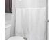 Cozy bathroom featuring a toilet and white shower curtain at 650 Island Way # 204, Clearwater Beach, FL 33767