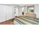 Bright bedroom featuring hardwood floors, double closets, and ensuite bathroom access at 650 Island Way # 204, Clearwater Beach, FL 33767
