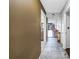 Hallway with gray tile floors leading to a living area with hardwood floors at 650 Island Way # 204, Clearwater Beach, FL 33767