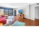 Cozy living room featuring hardwood floors, bright furniture, and a water view at 650 Island Way # 204, Clearwater Beach, FL 33767