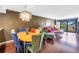 Open-concept living and dining area with hardwood floors and a modern chandelier at 650 Island Way # 204, Clearwater Beach, FL 33767