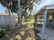 Spacious backyard area featuring fencing, mature trees, and a glimpse of the home's screened porch at 6706 Del Prado Ter, New Port Richey, FL 34652