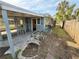 Exterior view of a home featuring a screened porch, blue paint, and minimal landscaping at 6706 Del Prado Ter, New Port Richey, FL 34652