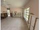 View of the living room featuring tile floors, a ceiling fan, and a window at 6706 Del Prado Ter, New Port Richey, FL 34652