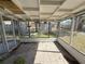 Enclosed sunroom featuring tiled flooring and views of the backyard at 6706 Del Prado Ter, New Port Richey, FL 34652