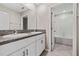 Bathroom featuring double sinks, granite counters, and a bathtub/shower combo at 7205 Ronnie Gardens Ct, Tampa, FL 33619