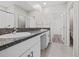 Bathroom with double vanity, granite countertops, and tiled floors at 7205 Ronnie Gardens Ct, Tampa, FL 33619