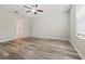 Bright bedroom with neutral walls, modern ceiling fan, and wood-look flooring at 7205 Ronnie Gardens Ct, Tampa, FL 33619