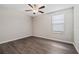 Bright bedroom with a ceiling fan, window with blinds, and neutral paint at 7205 Ronnie Gardens Ct, Tampa, FL 33619