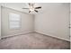 Comfortable bedroom with neutral carpet, a ceiling fan, and ample natural light at 7205 Ronnie Gardens Ct, Tampa, FL 33619