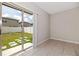 Bedroom view to backyard via sliding glass doors and stepping stones at 7205 Ronnie Gardens Ct, Tampa, FL 33619