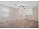 Upstairs bonus room with neutral carpet and a ceiling fan at 7205 Ronnie Gardens Ct, Tampa, FL 33619