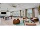 Bright clubhouse featuring a billiard table, comfortable seating, and large windows for natural light at 7205 Ronnie Gardens Ct, Tampa, FL 33619