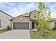 Charming two-story home features a two-car garage and well-maintained landscaping at 7205 Ronnie Gardens Ct, Tampa, FL 33619