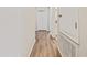 Hallway featuring wood-look flooring and access to the bathroom at 7205 Ronnie Gardens Ct, Tampa, FL 33619