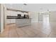 Open-concept kitchen featuring stainless steel appliances and white cabinetry at 7205 Ronnie Gardens Ct, Tampa, FL 33619