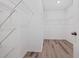 Walk-in closet with wire shelving and wood-look flooring at 7205 Ronnie Gardens Ct, Tampa, FL 33619