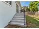 Exterior view of a home's back patio area with steps leading to backyard at 8605 N Taliaferro Ave, Tampa, FL 33604
