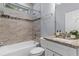 This bathroom has granite countertop, a white vanity, and a tiled shower at 8605 N Taliaferro Ave, Tampa, FL 33604