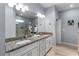 Bathroom featuring dual sinks with granite countertops and modern fixtures plus a glass enclosed shower at 8605 N Taliaferro Ave, Tampa, FL 33604