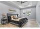 Comfortable bedroom featuring a tray ceiling, ceiling fan, and a view of the pool from the window at 8605 N Taliaferro Ave, Tampa, FL 33604