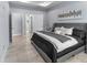 Spacious bedroom showcasing neutral tones, wood-look tile flooring, and a large window for ample natural light at 8605 N Taliaferro Ave, Tampa, FL 33604