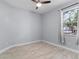 Bright bedroom with neutral walls, tile flooring, and natural light from a window at 8605 N Taliaferro Ave, Tampa, FL 33604