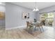 Bright dining area with modern table set and sliding glass doors to the outdoors at 8605 N Taliaferro Ave, Tampa, FL 33604