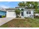Charming single-Gathering home featuring a garage and well-maintained front yard, perfect for curb appeal at 8605 N Taliaferro Ave, Tampa, FL 33604