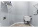 Well lit laundry room with a utility sink and wire rack shelving unit at 8605 N Taliaferro Ave, Tampa, FL 33604
