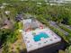 Aerial view of a community pool and clubhouse bordered by lush greenery and tranquil waterways at 9100 Dr Martin Luther King Jr N St # 314, St Petersburg, FL 33702